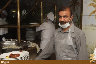 سفيد پوشي كه دو خدمت به زائر مي‌كند؛ هم طبابت و هم توزيع غذا